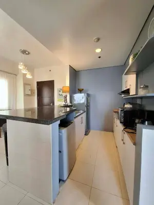 a large kitchen with a large island in the middle at Cozy Hotel-Style 2 Bedroom Condo Unit at Eastbay Residences by Rockwell in Manila