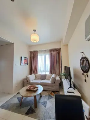 a living room with a couch and a table at Cozy Hotel-Style 2 Bedroom Condo Unit at Eastbay Residences by Rockwell in Manila