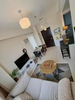 a living room with a white couch and a table at Cozy Hotel-Style 2 Bedroom Condo Unit at Eastbay Residences by Rockwell in Manila