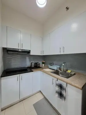 a kitchen with white cabinets and a sink at Cozy Hotel-Style 1 Bedroom Condo Unit Bryant Tower 12E at Eastbay Residences by Rockwell in Manila
