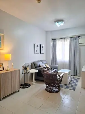 a living room with a couch and a table at Cozy Hotel-Style 1 Bedroom Condo Unit Bryant Tower 12E at Eastbay Residences by Rockwell in Manila
