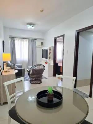 a living room with a dining table and a living room at Cozy Hotel-Style 1 Bedroom Condo Unit Bryant Tower 12E at Eastbay Residences by Rockwell in Manila