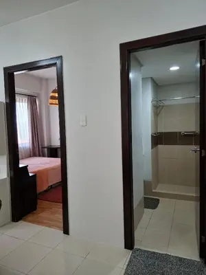 a bathroom with a glass door leading to a bedroom at Cozy Hotel-Style 1 Bedroom Condo Unit Bryant Tower 12E at Eastbay Residences by Rockwell in Manila
