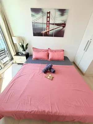 a large pink bed in a room with a bridge picture at Azure Destiny's Suites 1912 in Manila