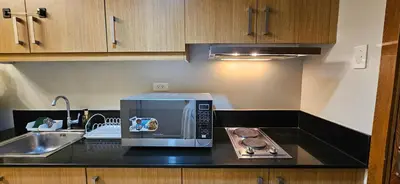 a microwave sitting on a counter in a kitchen at Low Floor 1BR Balcony Shell near MOA Shell001 in Manila