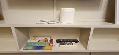 a shelf with books and a roll of paper towels at Low Floor 1BR Balcony Shell near MOA Shell001 in Manila