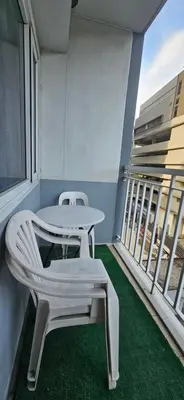 a balcony with a table and two chairs and a window at Low Floor 1BR Balcony Shell near MOA Shell001 in Manila