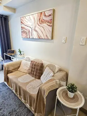 a living room with a couch and a table at Haven Home in Manila
