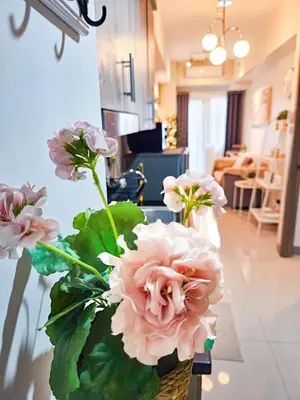 a vase filled with pink flowers on a table at Haven Home in Manila