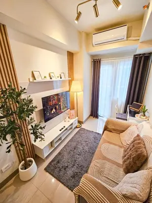 a living room with a couch and a tv at Haven Home in Manila