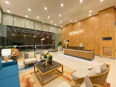 a lobby with a couch and chairs and a table at Cozy maple grove studio with hot shower in General Trias