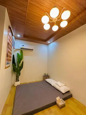 a room with a bed and a ceiling fan at Tan's Homestay in Trece Martires