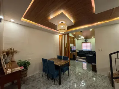 a living room with a table and a couch at Tan's Homestay in Trece Martires