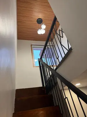 a staircase in a house with a ceiling at Tan's Homestay in Trece Martires