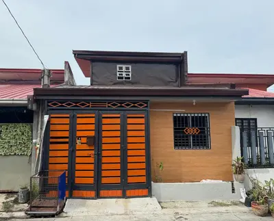 a small house with orange doors at Tan's Homestay in Trece Martires