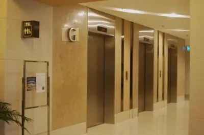 a row of elevators in a hallway in a building at MOA Condo Stay with balcony Pool View 2 Beds in Manila