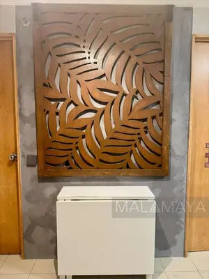 a wooden wall art on a wall in a room at Malamaya Staycation in Manila