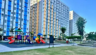 a playground in front of a large building at Malamaya Staycation in Manila