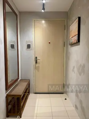 a door in a room with a mirror and a staircase at Malamaya Staycation in Manila