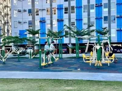 a playground in a city with people playing on it at Malamaya Staycation in Manila