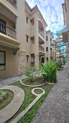 a large apartment building with a walkway in front of it at 924 Villa Tropez Tower in Manila