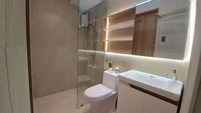 a bathroom with a toilet and a sink and a shower at 924 Villa Tropez Tower in Manila