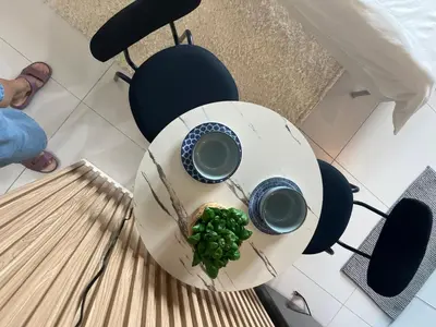 a table with two cups of coffee and a bowl of peas at Bleau Haven KL Service Residences Makati in Manila