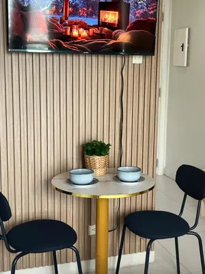 a table with two blue bowls on it with two chairs at Bleau Haven KL Service Residences Makati in Manila