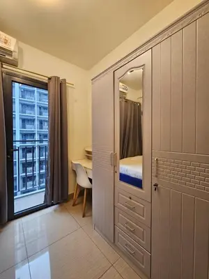 a bedroom with a bed and a desk with a window at Shore 2 Tower 2 Pool View 1BR near MOA and NAIA Shore003 in Manila