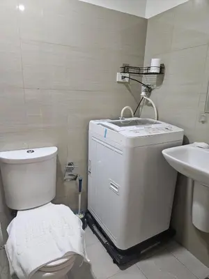 a bathroom with a toilet and a sink at Shore 2 Tower 2 Pool View 1BR near MOA and NAIA Shore003 in Manila