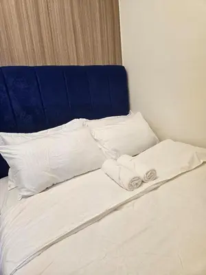 a bed with white pillows and towels on it at Shore 2 Tower 2 Pool View 1BR near MOA and NAIA Shore003 in Manila