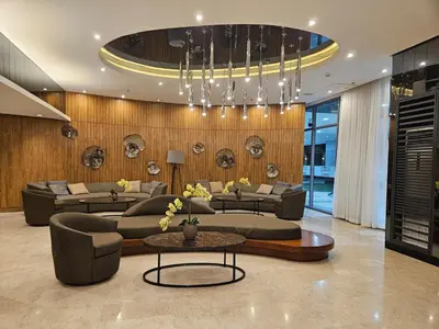 a living room with couches and tables and a chandelier at Shore 2 Tower 2 Pool View 1BR near MOA and NAIA Shore003 in Manila