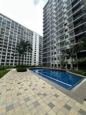 a swimming pool in front of two tall buildings at Gateway mall of asia shore 3 near Airport Malls in Manila