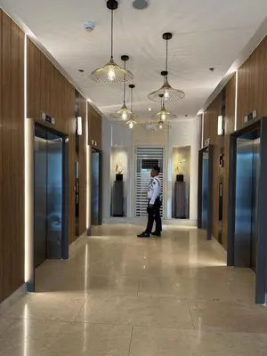 a man walking down a hallway in a building at Gateway mall of asia shore 3 near Airport Malls in Manila