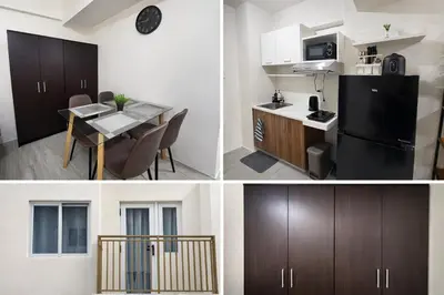 a kitchen with a black refrigerator and a table at Amaia Steps Sucat in Manila