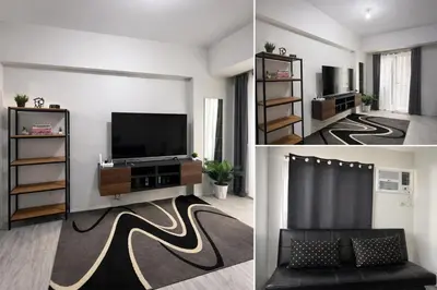 a living room with a tv and a couch at Amaia Steps Sucat in Manila
