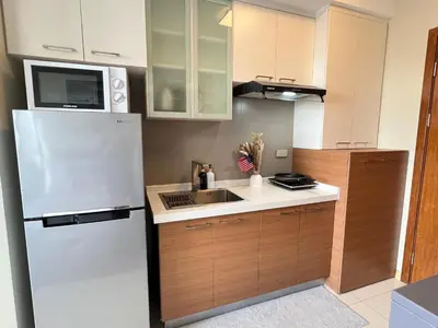 a kitchen with a white refrigerator and a sink at Great View at Pioneer Mandaluyong Free Pool Gym Netflix Fast Wifi in Manila