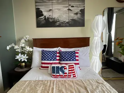 two patriotic pillows on a bed in a bedroom at Great View at Pioneer Mandaluyong Free Pool Gym Netflix Fast Wifi in Manila