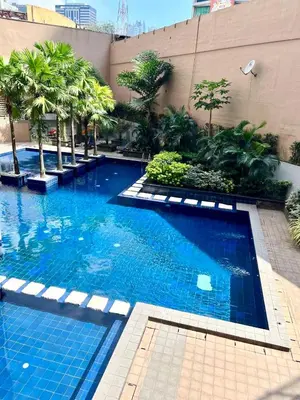 a large swimming pool with palm trees and a building at Great View at Pioneer Mandaluyong Free Pool Gym Netflix Fast Wifi in Manila