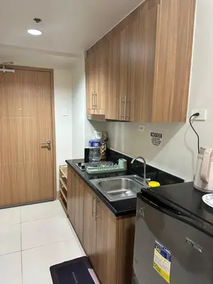 a kitchen with a sink and a counter top at Gateway Mall of Asia Near Airport in Manila