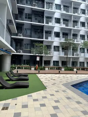 a large apartment building with a playground in front of it at Gateway Mall of Asia Near Airport in Manila