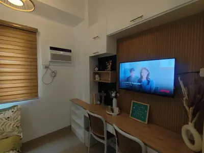 a living room with a flat screen tv on a wall at Naomi's Green Haven in Dasmariñas