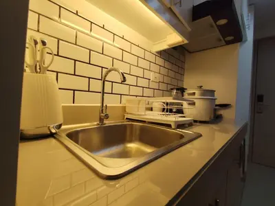 a kitchen counter with a sink and a stove at Naomi's Green Haven in Dasmariñas