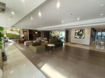 a lobby of a hotel with couches and a table at Naomi's Green Haven in Dasmariñas