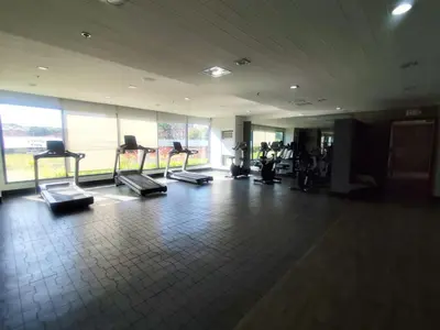 a gym with a row of tread machines in a room at Naomi's Green Haven in Dasmariñas