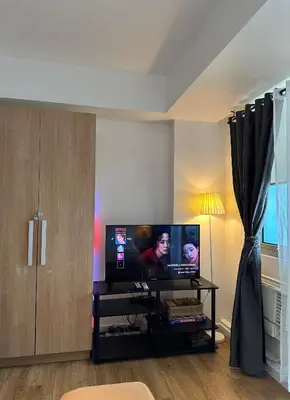 a living room with a large flat screen tv at Azure staycation in Manila