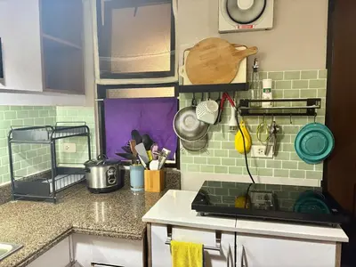 a kitchen with a sink and a counter top at Comfortable 1BR Pasig Apartment in Manila