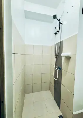 a bathroom with a shower with a shower head at Netflix and Chill Ephra's Place in Manila