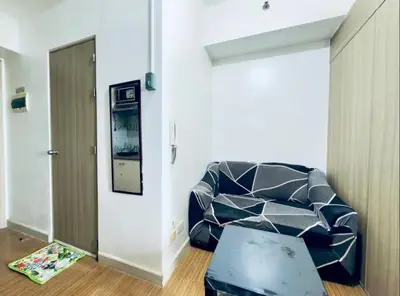 a living room with a couch and a mirror at Netflix and Chill Ephra's Place in Manila
