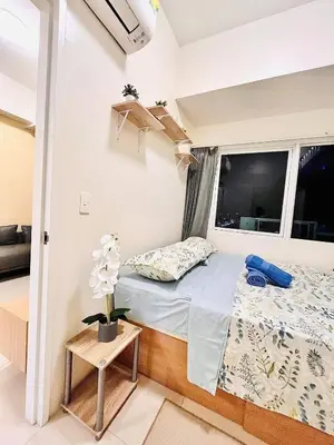 a small bedroom with a bed and a window at Staycation Casa Filipina in Manila